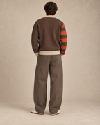 Back view of HLY WTR Heritage Carmel Cardigan with chocolate brown knit, bone trim and burnt orange striped sleeve