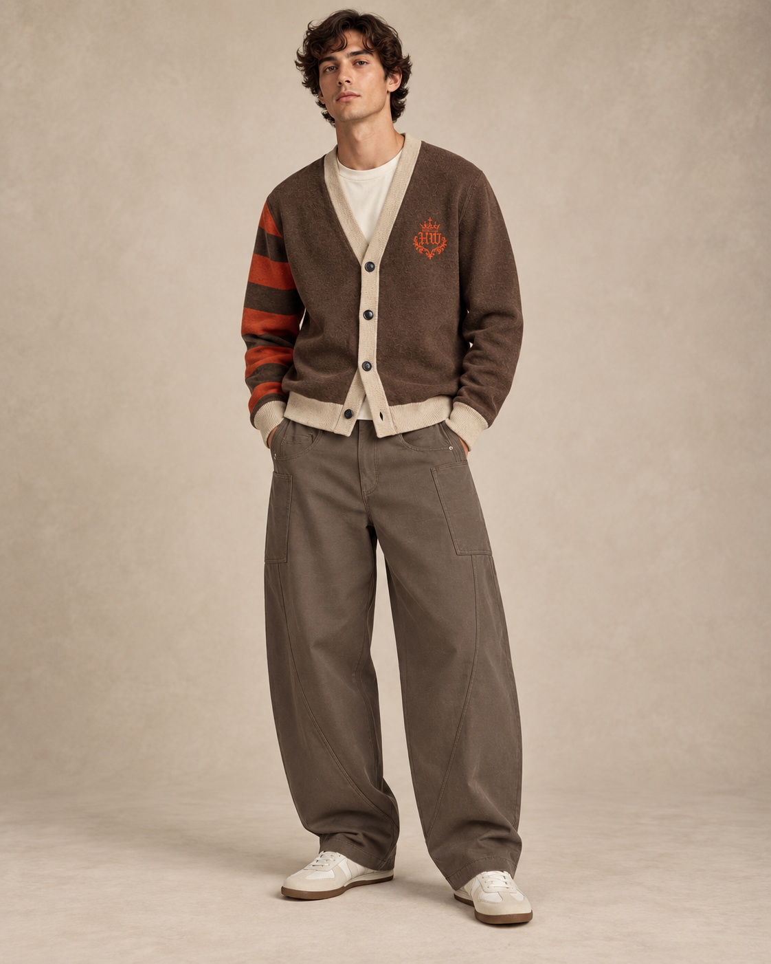 Model wearing HLY WTR Heritage Carmel Cardigan in chocolate brown with bone trim and burnt orange striped sleeve