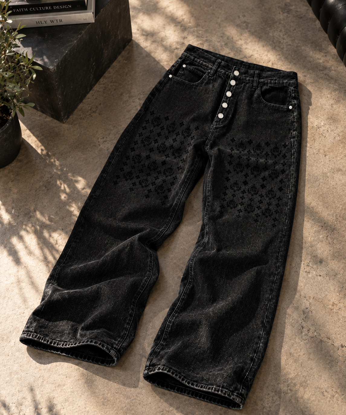 Front view of HLY WTR Heritage Monogram black wide-leg jeans featuring tonal HW monogram panels and exposed silver buttons.