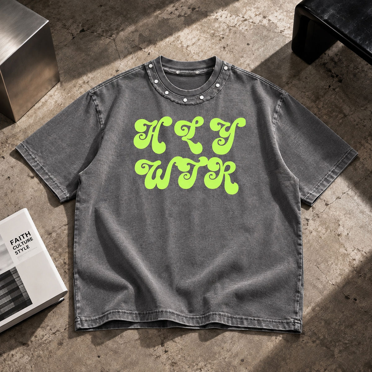 Front view of HLY WTR washed grey oversized T-shirt with neon green logo and studded collar
